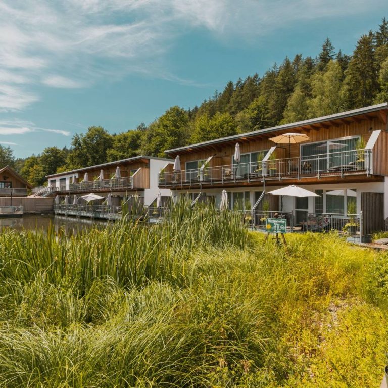 Hotelgebäude vor blauem Himmel und Wald